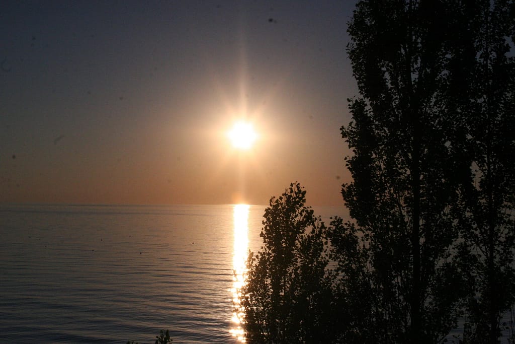 picture of the sun setting over the lake while camping at MacGregor Point Provincial Park